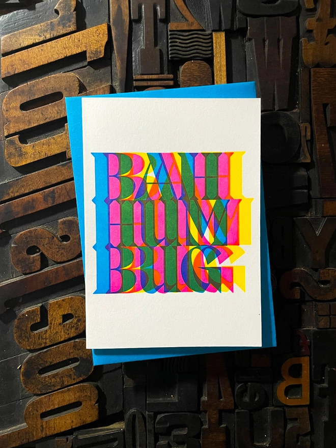 Bah Humbug! A beautiful typographic letterpress Christmas card set. Printed with rich vibrant and fluorescent blue, magenta and yellow inks with luxury matching and contrasting envelopes; ideal to send to your designer friends.