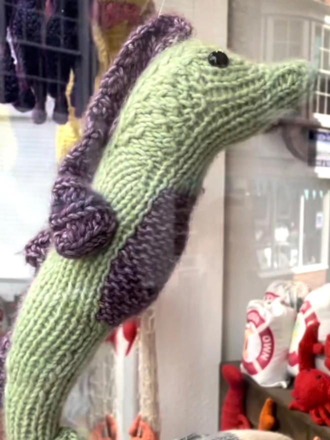 Seahorse Knit Kit. A knitted seahorse in green and purple.