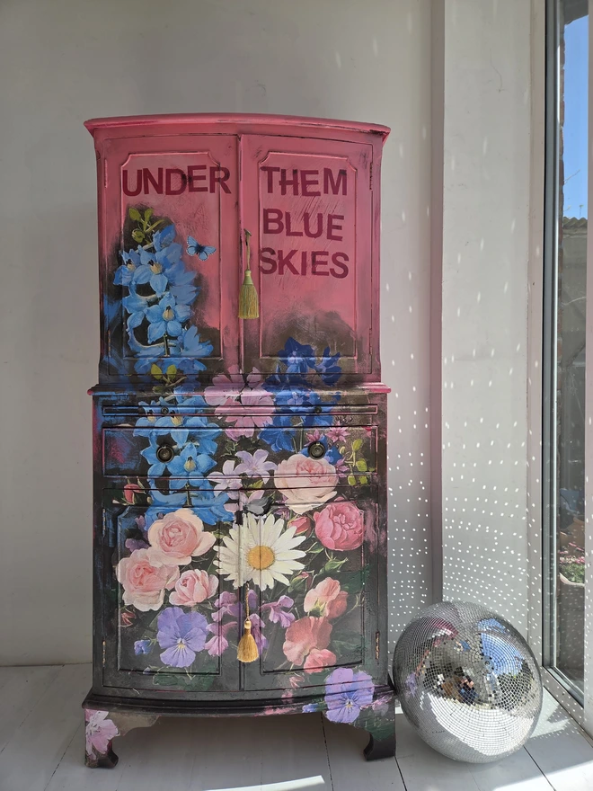 Painted vintage wooden cabinet with pink, blue and floral decoration