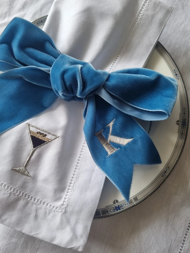 A blue velvet ribbon tied in a bow around a napkin