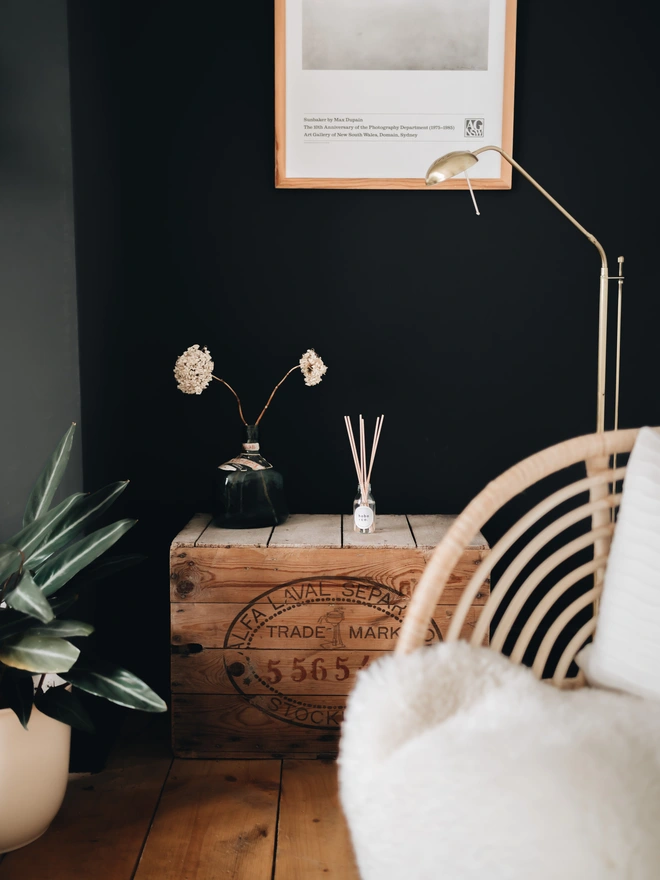 oakwood and tobacco reed diffuser in cosy living room