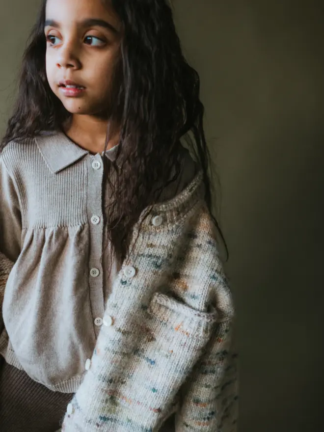 MABLI's 'Blewog' collection in the 'Jewel Speckle' colourway. This soft, fluffy, relaxed-fit cardigan features a speckled, cloud-like chunky yarn