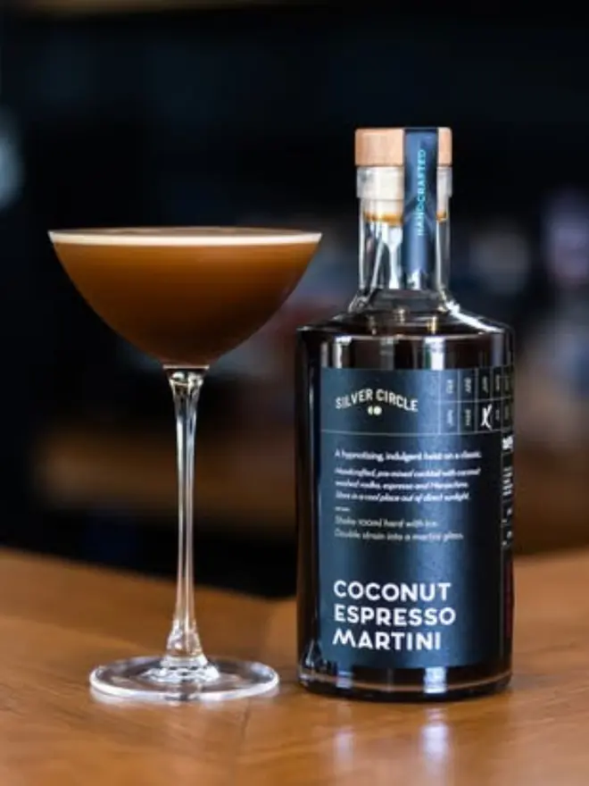 Coconut Espresso Martini, glass of espresso martini on a table. 