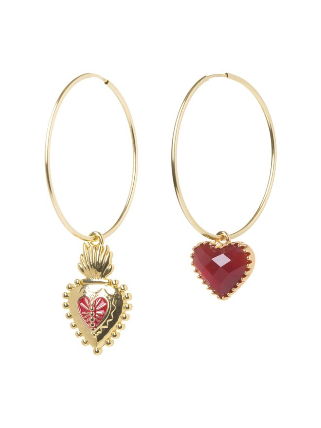 Pair of mismatching charm earrings with a Frida Kahlo Mexican heart and a read heart on a white background