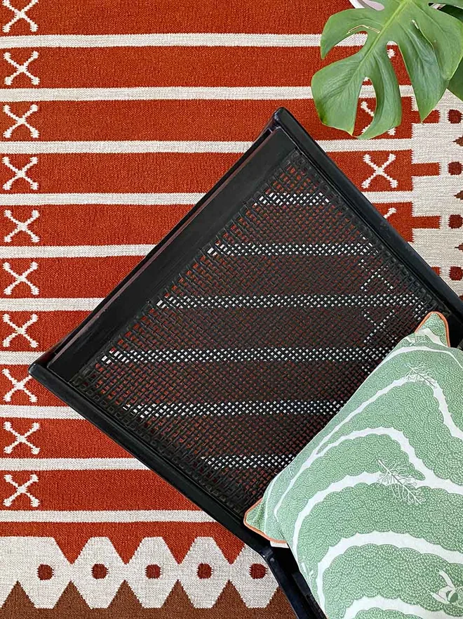 Darjeeling Flatweave Rug, a colourful rug in a living room. It is accompanied by other colourful furniture. 