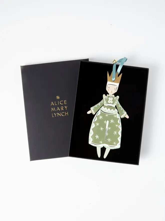 Prince Tree Dancer. wooden hanging prince decoration in an open black gift box embossed "alice mary lynch" in gold, with sage green robe, gold crown and duck egg blue ribbon with a jingle bell