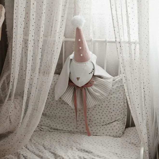 Rabbit Head Wall Mount, a cotton rabbit head wall decoration in a child's bedroom accompanied by other bedroom accessories. 