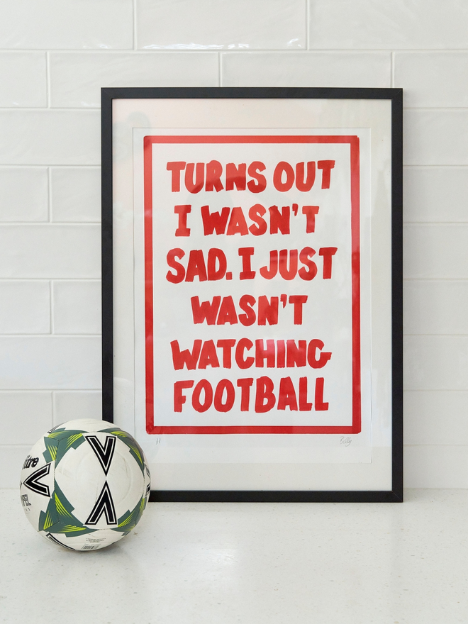 'Turns out I wasn't sad. I just wasn't watching football- print in red writing with a football next to it 