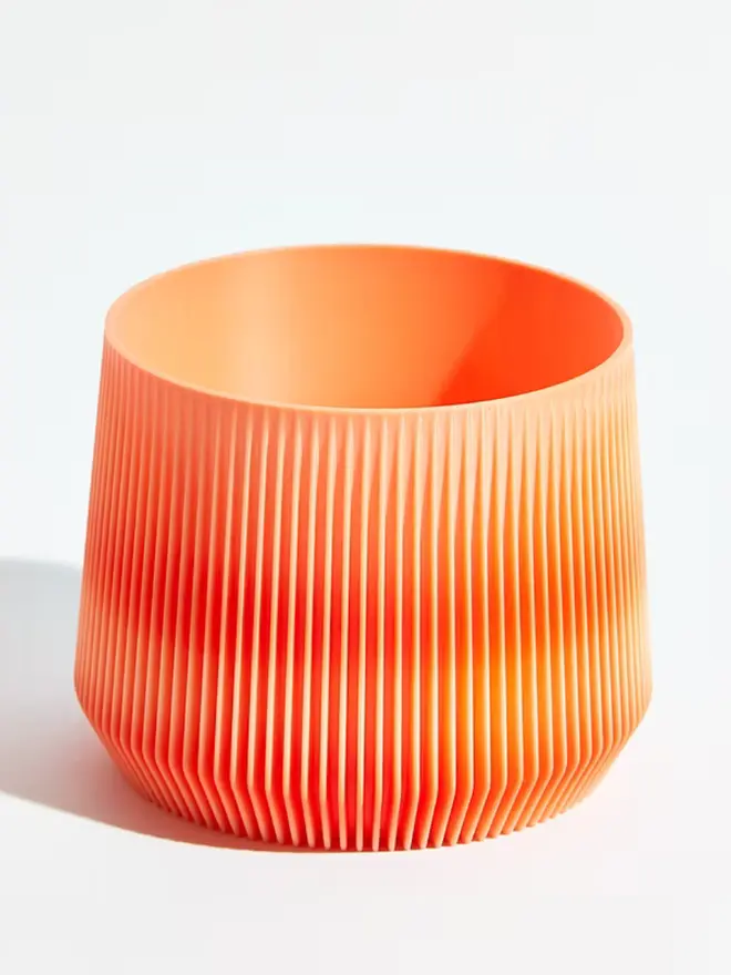Sustainable 3D Printed Coral Orange Plant Pot, pillar design, against a white background.