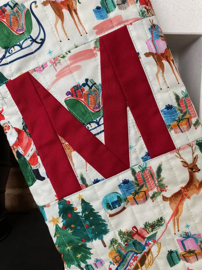 Cooper and Fred Personalised Christmas Stocking in a Christmas Scene Print with a Red M Letter