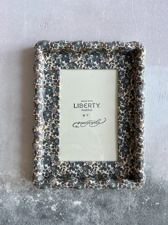 Liberty fabric covered wiggle mount frame on flat lay background