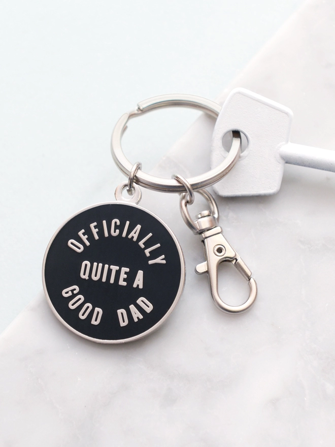 Black and silver enamel keyring with 'Officially Quite a Good Dad' design