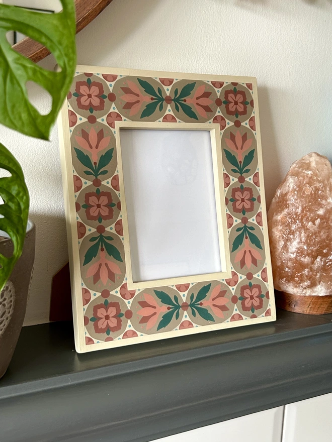 Folk art inspired hand painted decorated flower patterned photo frame painted in pinks, green, cream and light brown