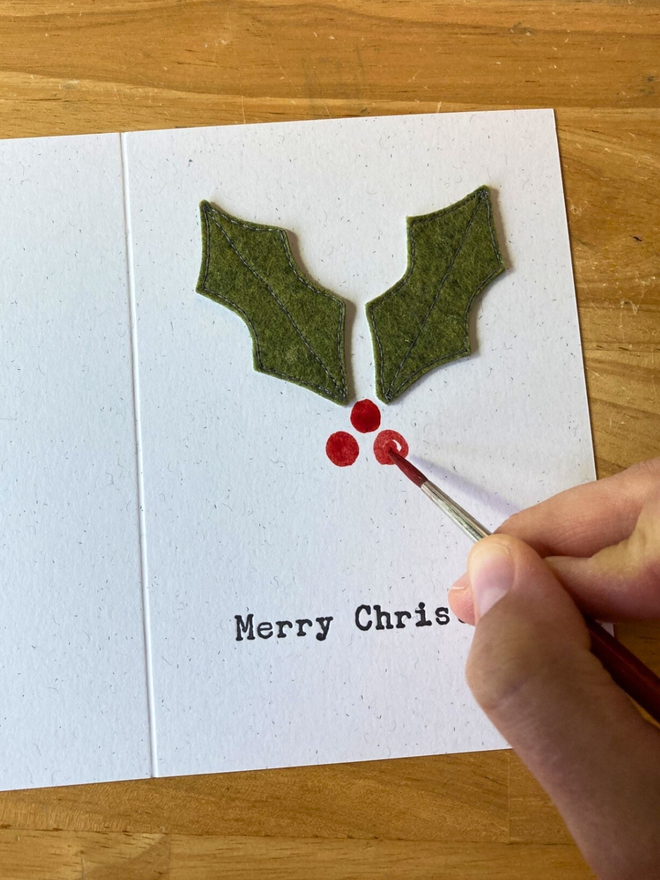 Hand painting red holly berries