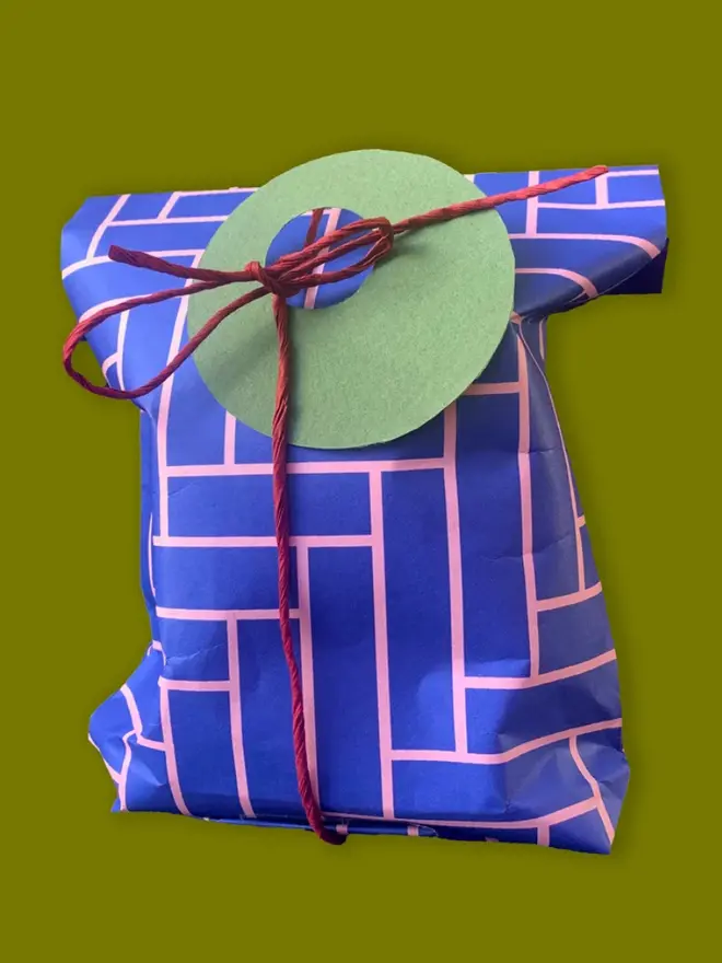 Geometric Herringbone Pattern Wrapping Paper, against a green background. 