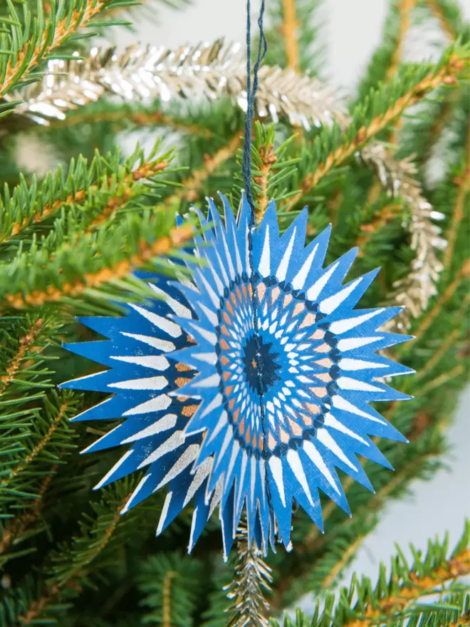 Close up blue and silver star on Christmas tree
