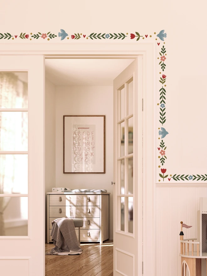 Ducks In A Row Folk Bird fabric wall stickers used as a border around door frame in girls nursery bedroom with double doors scandi decor 