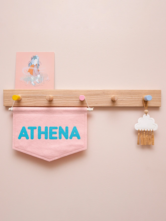 Personalised felt name banner in blush pink and electric blue.