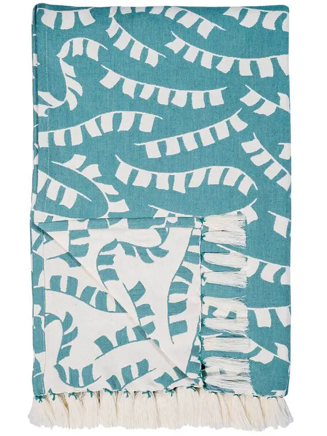 Teal Prayer Flag Woven Throw, a blue throw set on a plain white surface. 