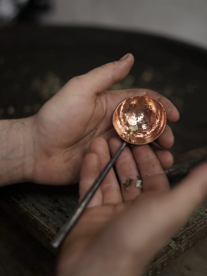Copper And Stainless Steel Scoop, a metal scoop sitting being held by someone. 