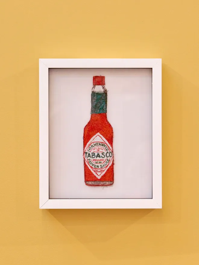 Tabasco Embroidery Wall Art with White Frame and Yellow Background