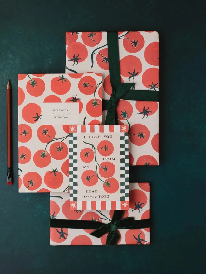 Tomatoes Notebooks tied with green ribbon alongside a tomato greeting card
