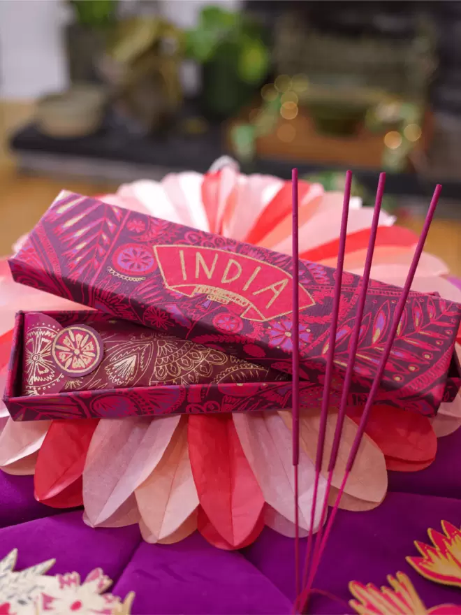 Close-up, detailed shot: pink India box with matching pink incense sticks 