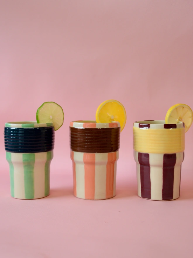 Striped ceramic tumblers with citrus garnish