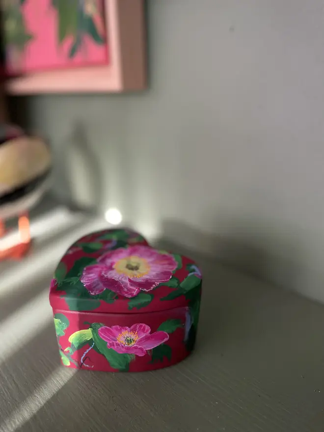 hand painted ceramic heart shaped keepsake box deep red background with pink Icelandic poppy flowers 