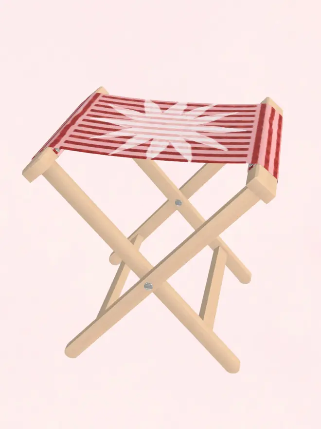 sun stripe folding stool. a burgundy and pink striped folding stool with a white sun motif.