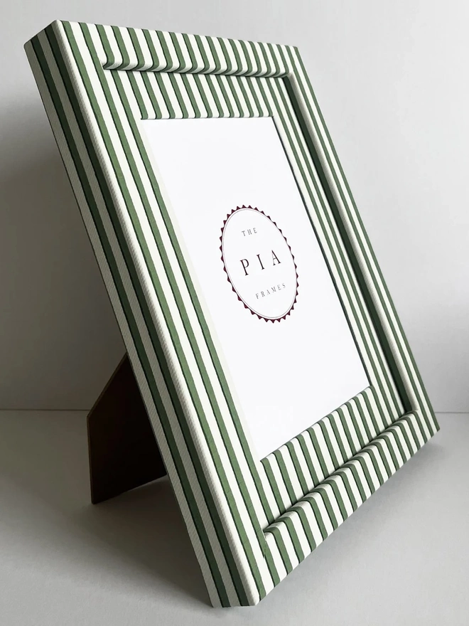 Green Vanguard Stripe Frame, a colourful striped frame sitting on a plain white surface. 