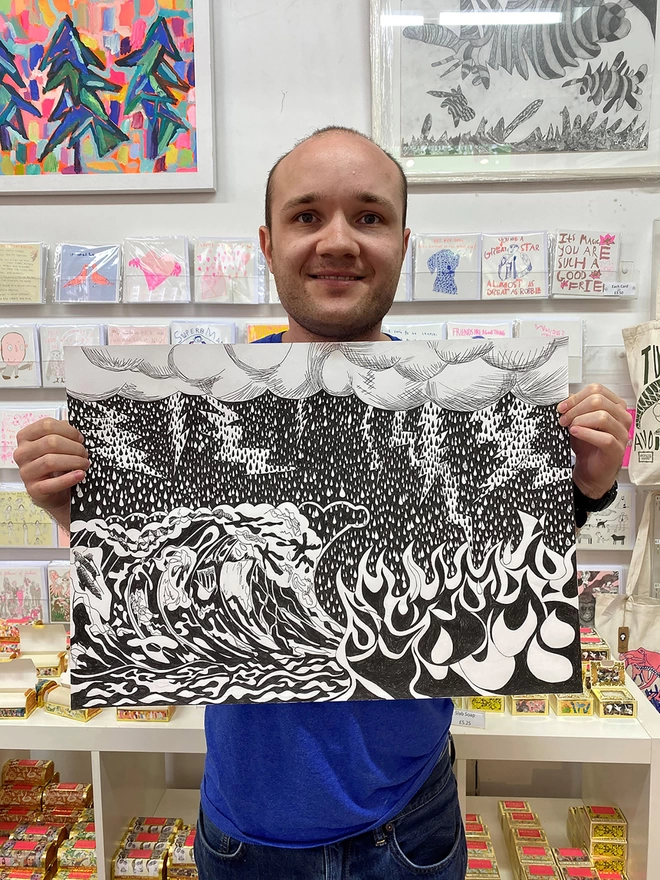 Happy artist holding original sketched artwork for rumble 100% organic cotton charity tea towel