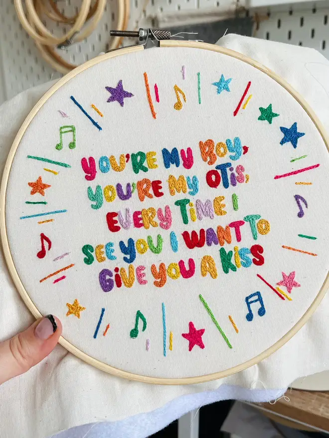 custom embroidered hoop. cotton hoop embroidered with multi coloured lettering.