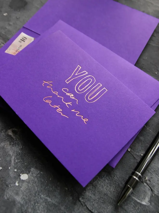 Hand foiled cash card or money wallet in a royal purple colour handfoiled in shiny rose gold foil text which says ‘you can thank me later’.