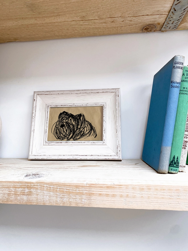 framed drawing of dog on brown paper