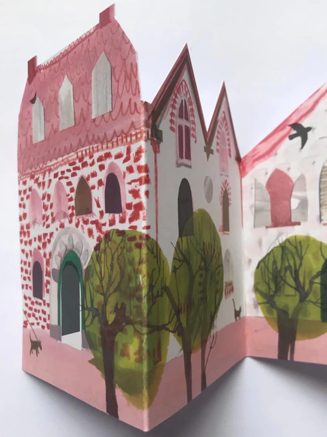 Folded concertina card showing illustrated pink houses 