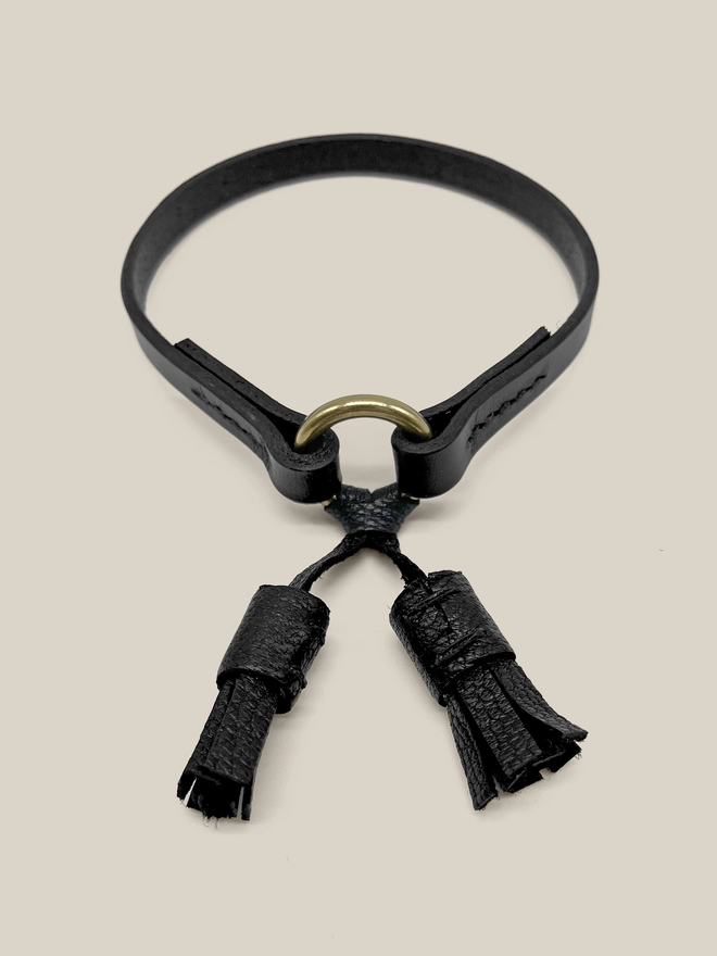front view of black house collar with tassels