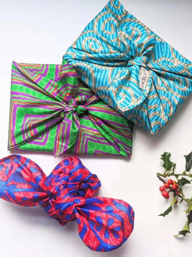 examples of gifts wrapped in green, purple and orange wrap and blue and yellow wrap