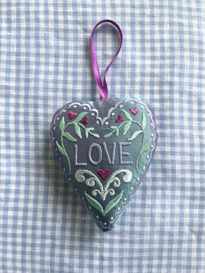 "LOVE" heart silk ornament with hearts, leaves and a scalloped edge (Pale blue silk with pale blue, pale green, cornflower blue and purple thread with a purple ribbon)