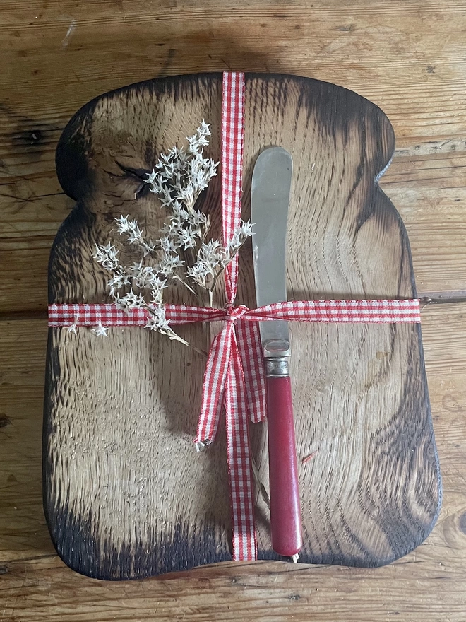 Toast Shaped Oak Serving Board with Ribbon, flowers and a butter knife