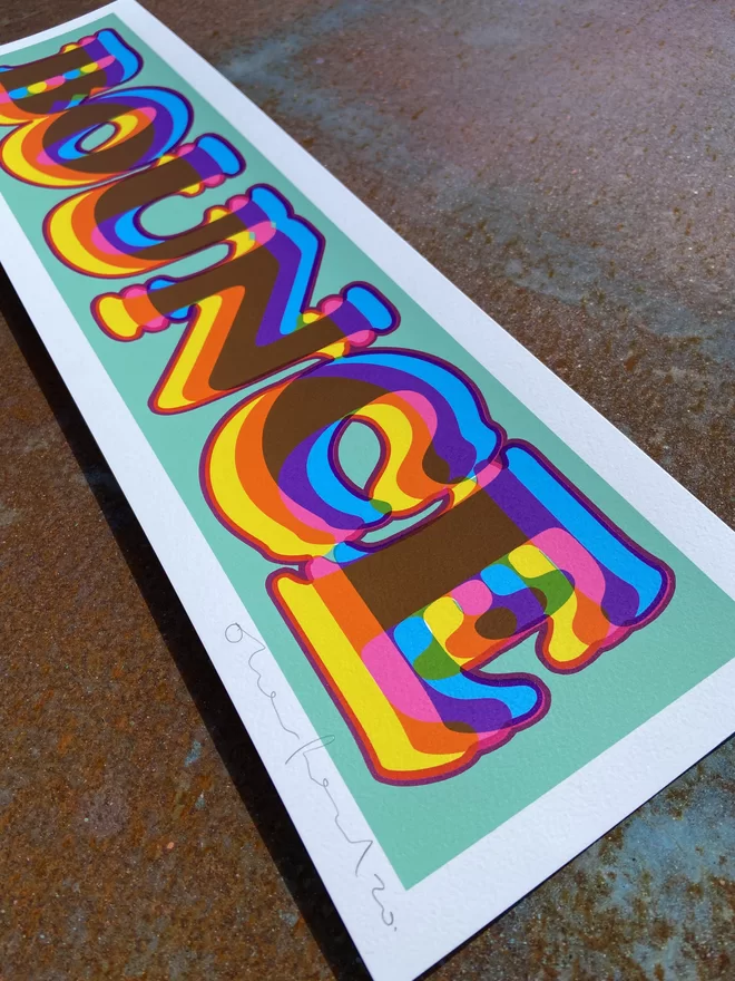 "Bounce" Hand Pulled Screen Print rectangular with green blue background and the word bounce printed on top in rainbow letters with pink outline 