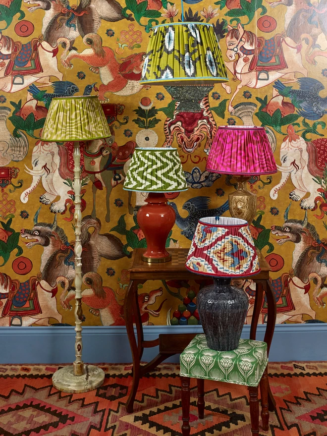 Five Colorful Ikat Lampshades in a Patterned Wallpapered Room