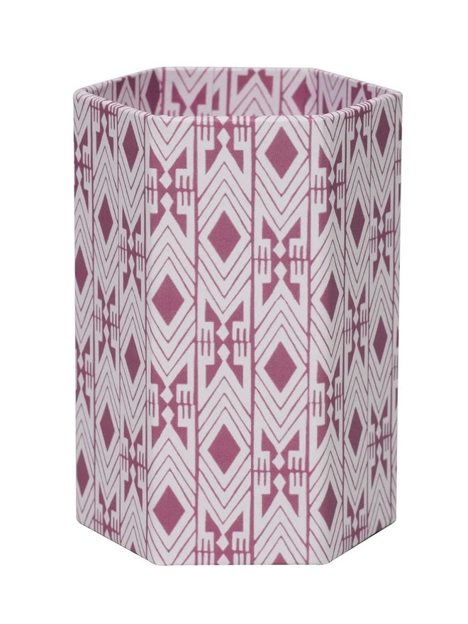 Tijan Hexagonal Brush Pot, a colourful patterned pencil pot sitting on a white surface against a plain backdrop. 
