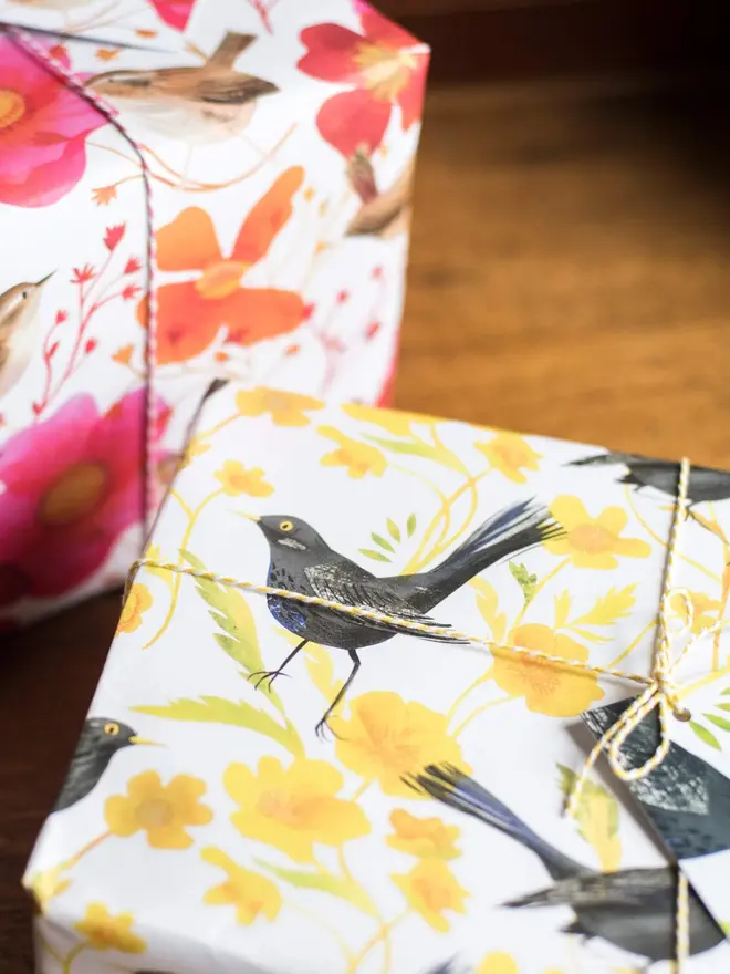 Recycled wrapping paper with a pattern of blackbirds and buttercups. Each sheet of luxury, 100% recycled paper comes with a matching gift tag.