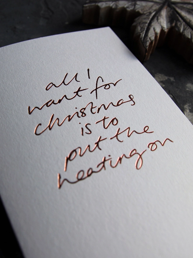 want to put the heating on white christmas card metallic script