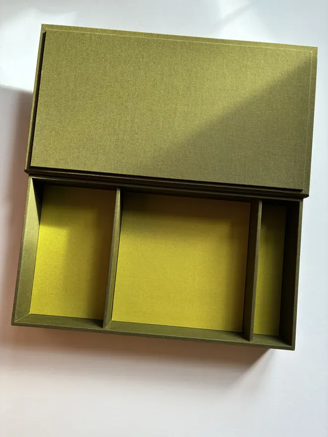 Open and empty handmade Christmas correspondence box covered in linen cloth with compartments