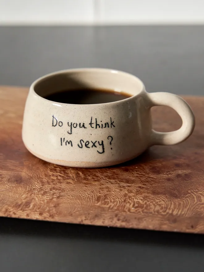 Cream ceramic mug with the words 'Do You Think I'm Sexy Mug' written on it 