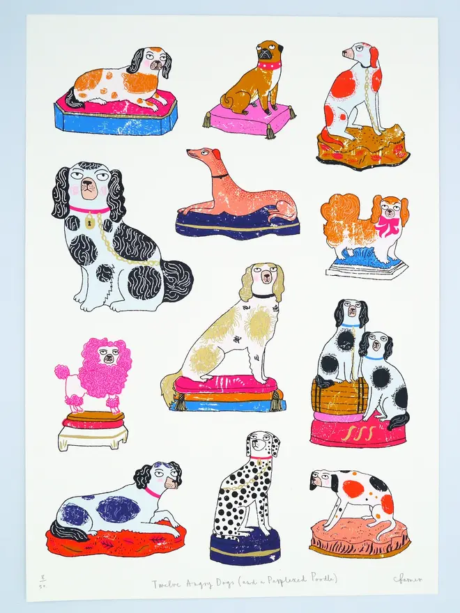 Staffordshire Pottery Dogs Screenprint Twelve Angry Dogs, a collection of colourful dog designs on a white screenprint. It sits against a baby blue backdrop. 