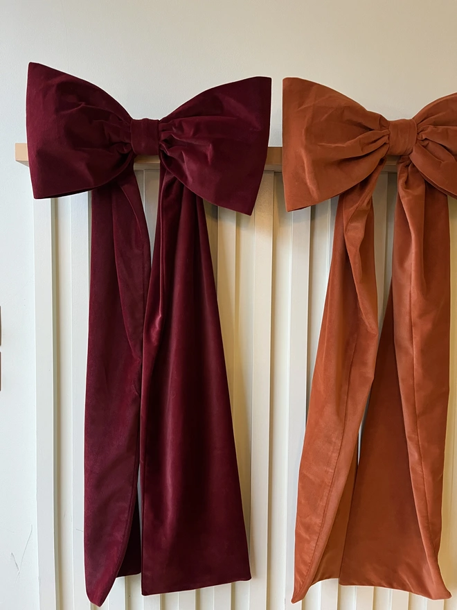 Wine Red Velvet Bow next to Rust Bow 