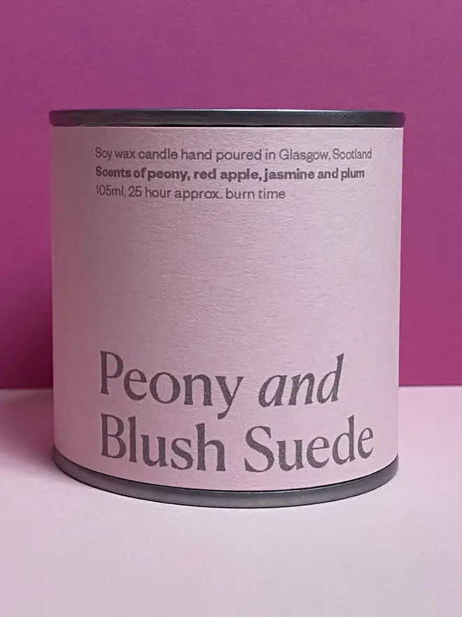 Peony and Blush Suede Soy Wax Candle Tin, against a pink background. 